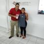 Omni Logistics employees smile with new shirt and office gear