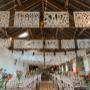 White Mexican wedding papel picado bunting hung at a wedding.