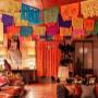 Day of the Dead papel picado banners and paper marigold flowers at a Dia de Muertos themed event at Soho House London.