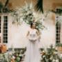 One of our brides posing with floral arrangements